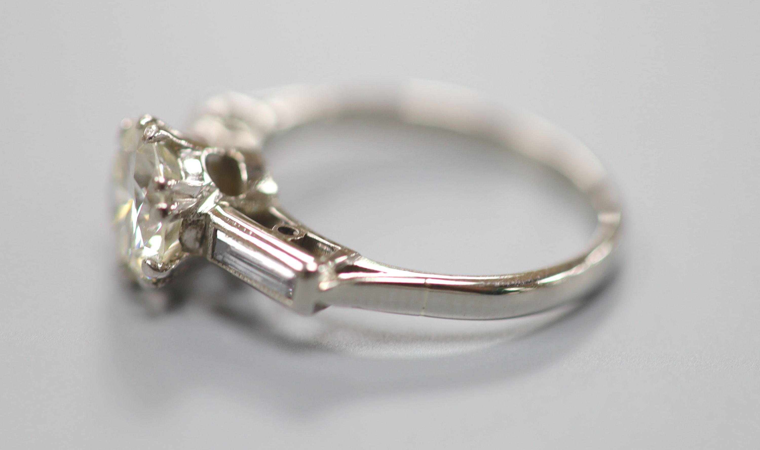 A modern platinum and single stone diamond ring,